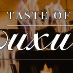 The words "Taste of Luxury" are written in a fancy white script and are superimposed over a photo of burning logs.